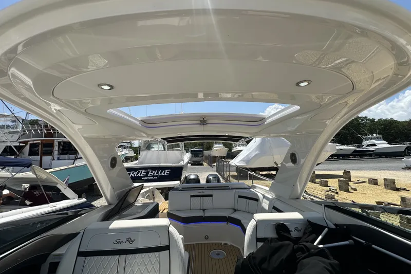 Slide: The Image of 2018 Sea Ray SLX 310 Outboard interior with sleek design and luxurious seating. - 18