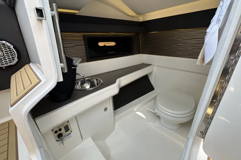 Slide: The Image of 2018 Sea Ray SLX 310 Outboard cabin with sink and toilet, featuring modern design. - 15