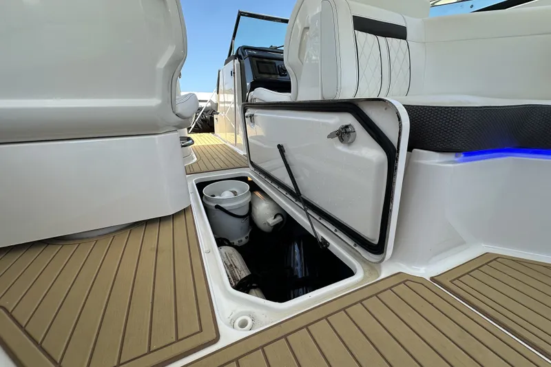 Slide: The Image of 2018 Sea Ray SLX 310 Outboard boat interior with open storage compartment. - 30