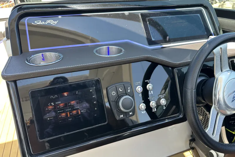 Slide: The Image of Control panel of a 2018 Sea Ray SLX 310 Outboard boat with steering wheel. - 23