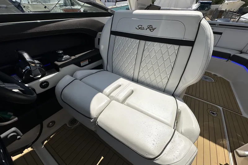 Slide: The Image of Luxurious interior of 2018 Sea Ray SLX 310 Outboard with premium seating and controls. - 19