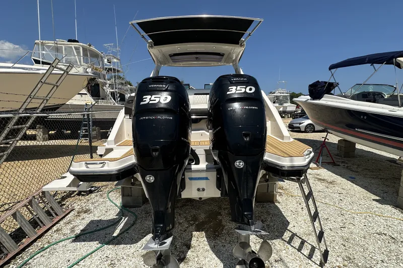 Slide: The Image of 2018 Sea Ray SLX 310 Outboard with twin 350 engines, docked in a marina. - 41