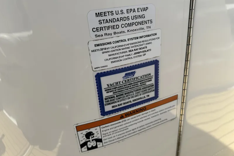 Slide: The Image of 2018 Sea Ray SLX 310 Outboard certification labels and warnings on boat surface. - 24