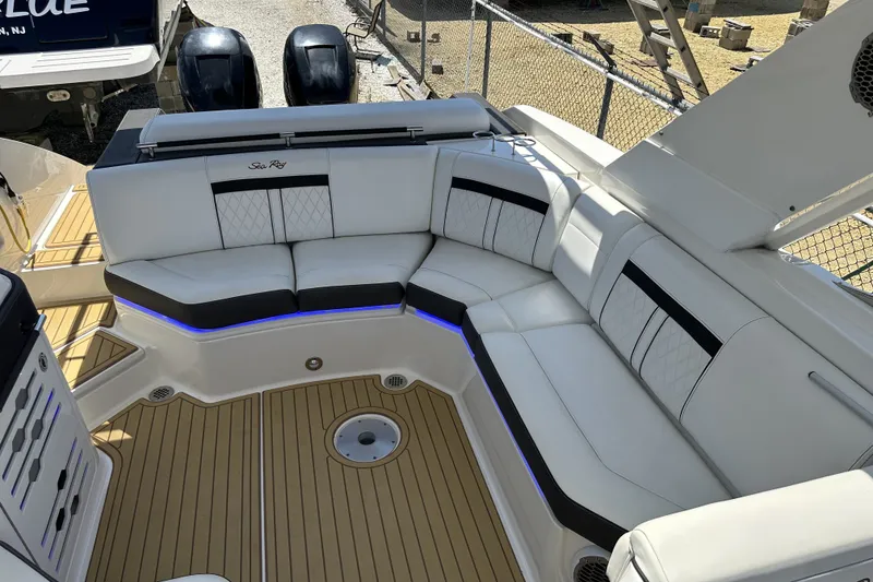 Slide: The Image of 2018 Sea Ray SLX 310 Outboard boat interior with luxurious seating and teak flooring. - 25