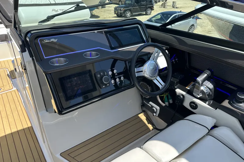 Slide: The Image of 2018 Sea Ray SLX 310 Outboard cockpit with modern controls and steering wheel. - 21