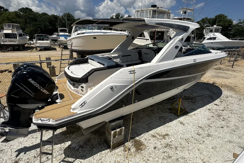 Slide: The Image of 2018 Sea Ray SLX 310 Outboard boat with Mercury engine in a marina setting. - 42