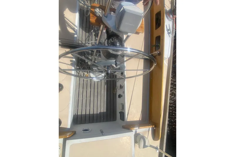 Slide: The Image of 1982 Bristol 40 sailboat cockpit with steering wheel and navigation controls. - 8