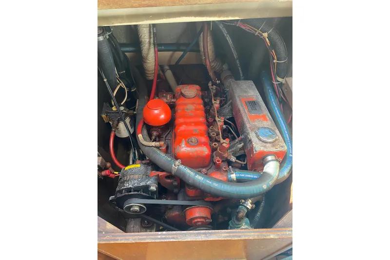 Slide: The Image of 1982 Bristol 40 engine compartment with red engine components and visible wiring. - 4