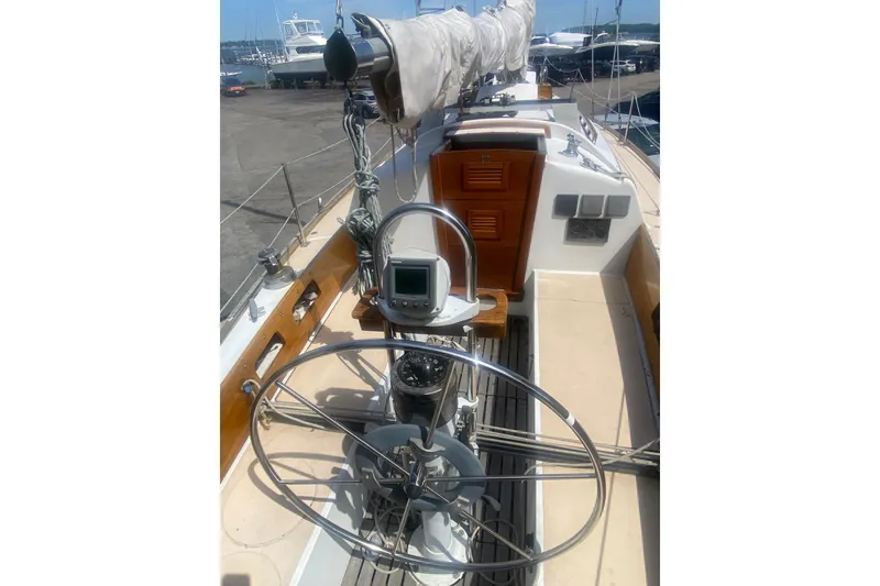 Slide: The Image of 1982 Bristol 40 sailboat cockpit with steering wheel and navigation equipment. - 11