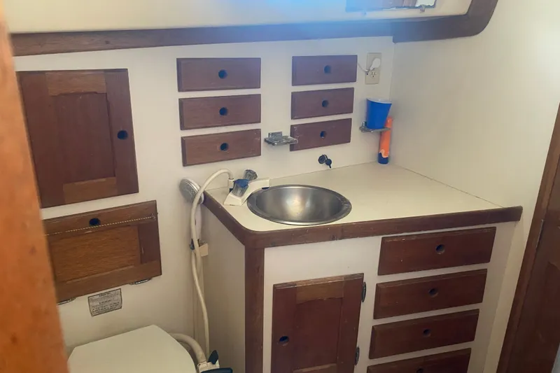 Slide: The Image of 1982 Bristol 40 yacht bathroom with wooden cabinets and stainless steel sink. - 5