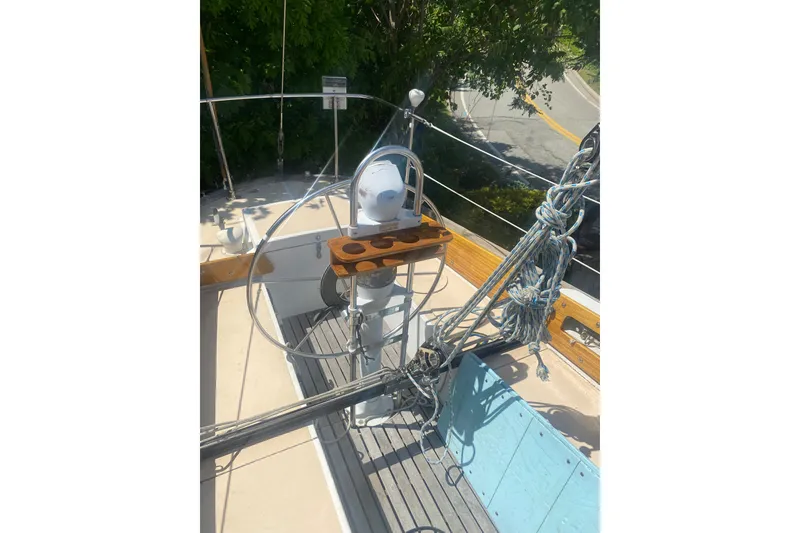 Slide: The Image of 1982 Bristol 40 sailboat cockpit with steering wheel and rigging ropes. - 16