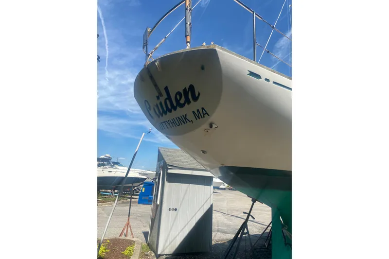 Slide: The Image of 1982 Bristol 40 sailboat on land, displaying "Cuttyhunk, MA" on the stern. - 21