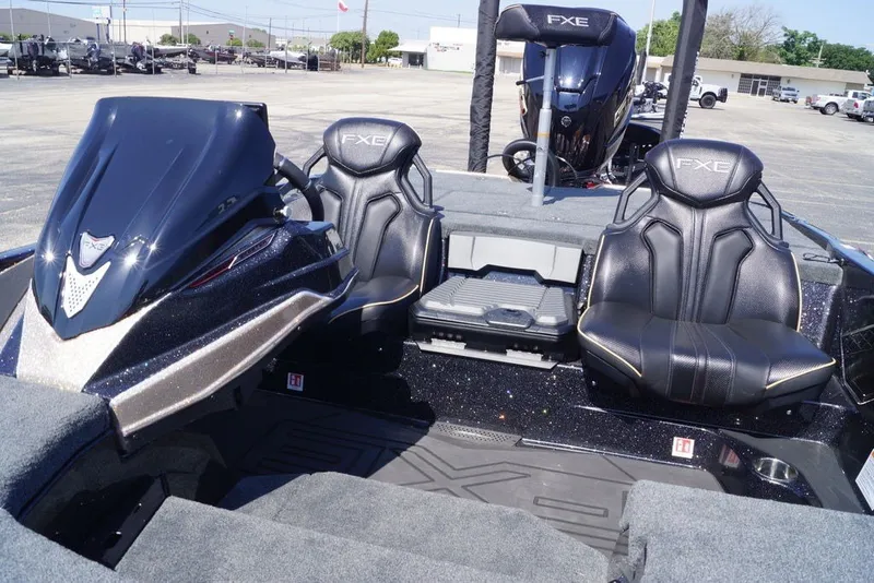 Slide: The Image of 2027 Skeeter FXE21 Limited boat interior with sleek black seats and modern dashboard. - 17