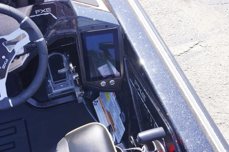 Slide: The Image of 2027 Skeeter FXE21 Limited boat dashboard with steering wheel and digital display. - 14