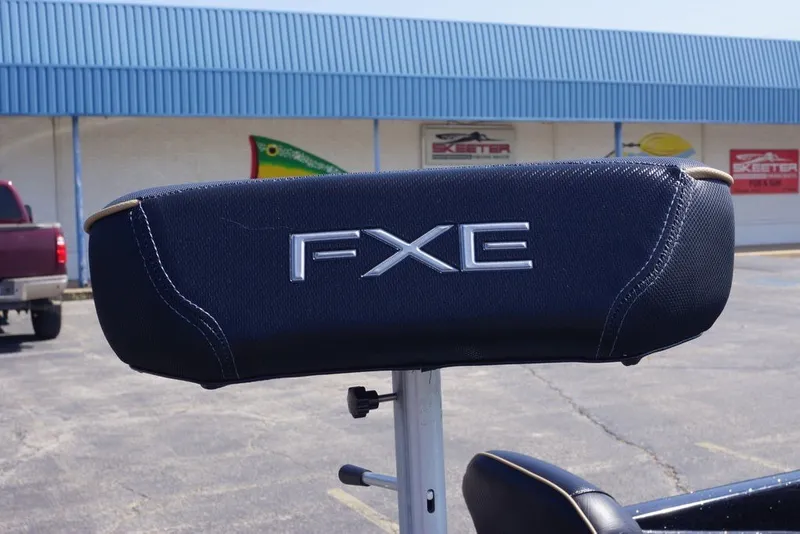 Slide: The Image of 2027 Skeeter FXE21 Limited boat seat with logo in a parking lot. - 16