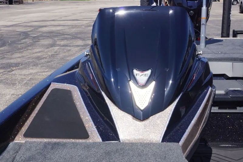 Slide: The Image of 2027 Skeeter FXE21 Limited boat, sleek design, parked on asphalt surface. - 25