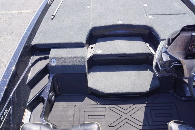 Slide: The Image of 2027 Skeeter FXE21 Limited boat interior with carpeted deck and seating area. - 15