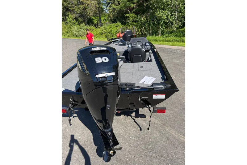 Slide: The Image of 2026 Crestliner XFC 179 boat with Mercury 90 engine, parked outdoors. - 7