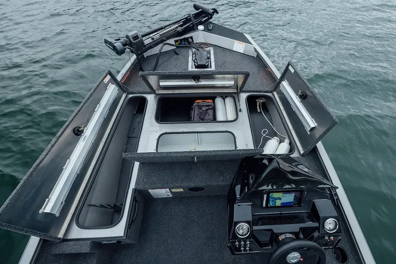 Slide: The Image of Manufacturer Provided Image: 2026 Crestliner XFC 179 boat interior with open storage compartments on water. - 14