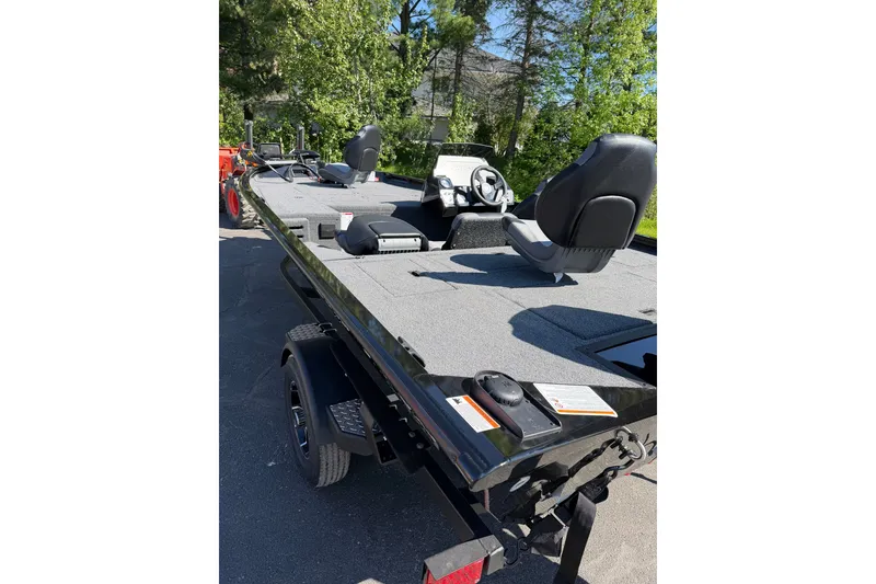 Slide: The Image of 2026 Crestliner XFC 179 fishing boat with seating, parked outdoors on a sunny day. - 8