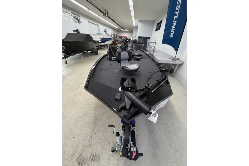 Slide: The Image of 2026 Crestliner XFC 179 fishing boat in showroom, featuring sleek design and modern equipment. - 3
