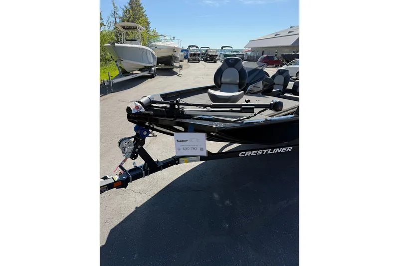 Slide: The Image of 2026 Crestliner XFC 179 boat on display in a sunny outdoor showroom. - 10