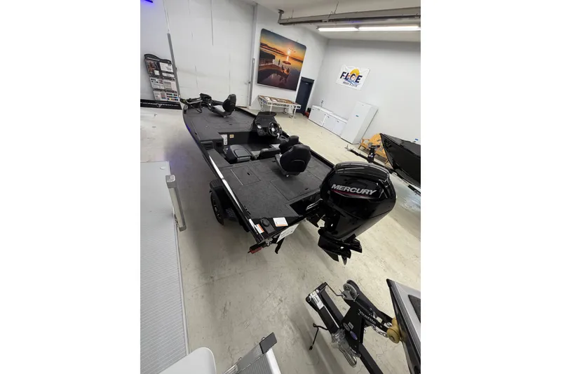 Slide: The Image of 2026 Crestliner XFC 179 fishing boat with Mercury outboard motor in showroom. - 5