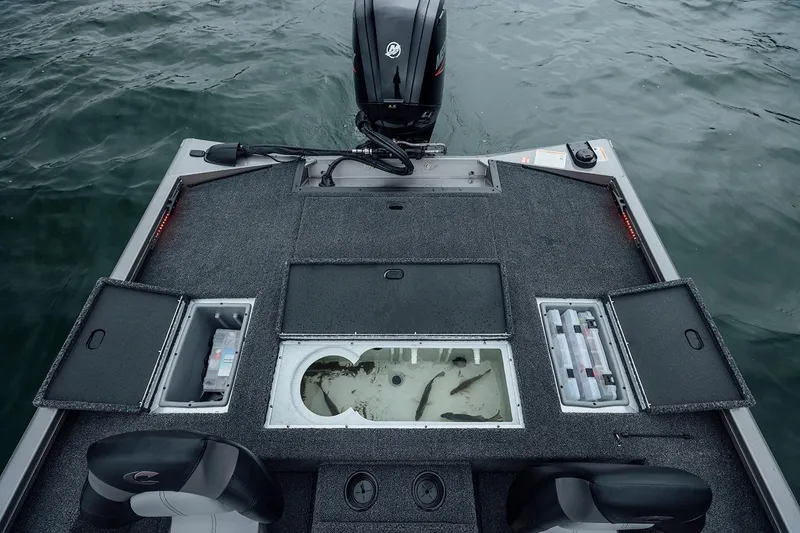 Slide: The Image of Manufacturer Provided Image: 2026 Crestliner XFC 179 boat deck with storage compartments and livewell on water. - 16