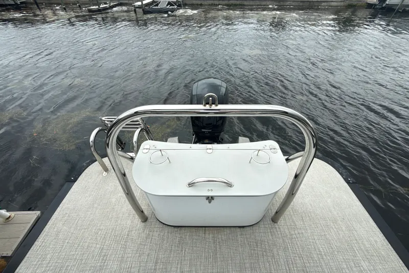 Slide: The Image of 2021 Avalon LSV 2285 QL boat with motor, docked on calm water. - 14
