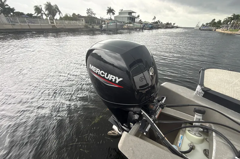 Slide: The Image of 2021 Avalon LSV 2285 QL with Mercury outboard motor on a calm waterway. - 15