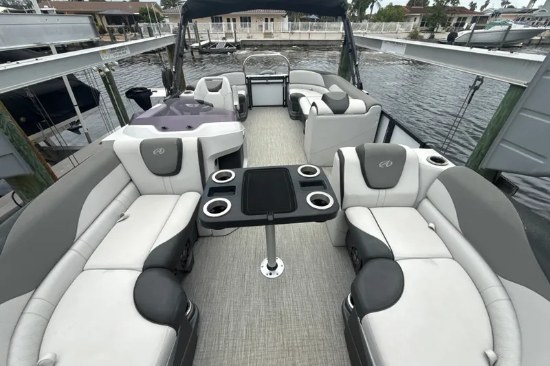 Slide: The Image of Luxurious 2021 Avalon LSV 2285 QL pontoon boat interior with plush seating and cup holders. - 13