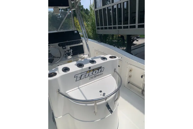 Slide: The Image of 2005 Triton 2895 CC boat interior with steering console and controls. - 10