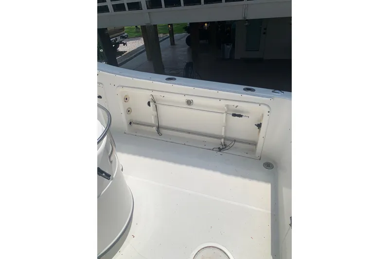 Slide: The Image of 2005 Triton 2895 CC boat interior, featuring a clean, spacious deck area. - 9