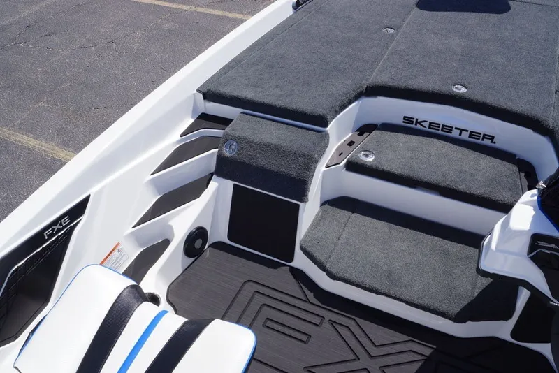 Slide: The Image of 2027 Skeeter FXE20 Limited boat interior with carpeted deck and seating. - 21