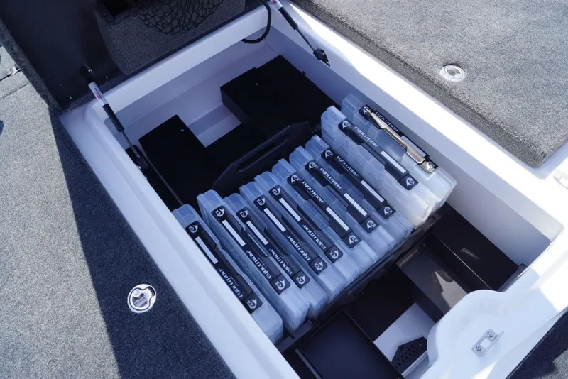 Slide: The Image of Storage compartment in 2027 Skeeter FXE20 Limited boat, featuring organized tackle boxes. - 22