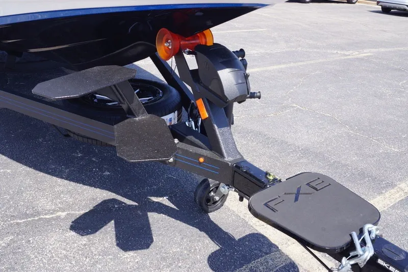Slide: The Image of Trailer hitch of 2027 Skeeter FXE20 Limited boat in parking lot. - 2
