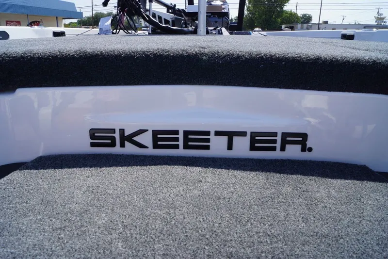 Slide: The Image of 2027 Skeeter FXE20 Limited boat deck with logo, featuring carpeted surface. - 19