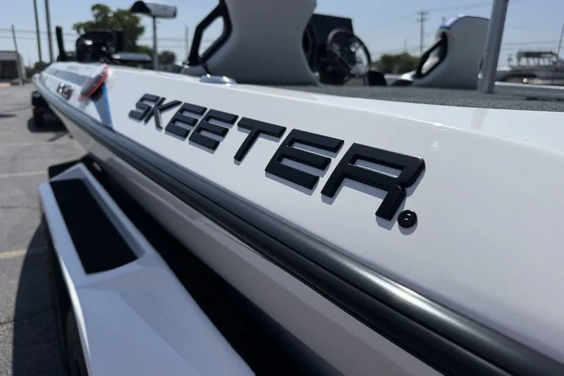 Slide: The Image of 2027 Skeeter FXE20 Limited boat, close-up of logo on sleek white exterior. - 15