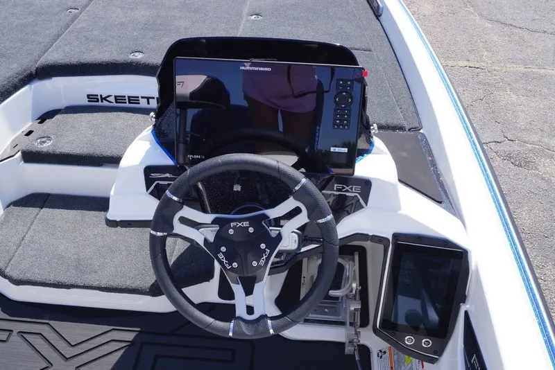 Slide: The Image of 2027 Skeeter FXE20 Limited boat dashboard with steering wheel and electronic controls. - 18