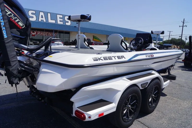 Slide: The Image of 2027 Skeeter FXE20 Limited boat on trailer at dealership parking lot. - 9
