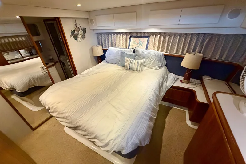 Slide: The Image of Cozy bedroom in 1994 Carver 440 Aft Cabin Motor Yacht with elegant decor. - 24