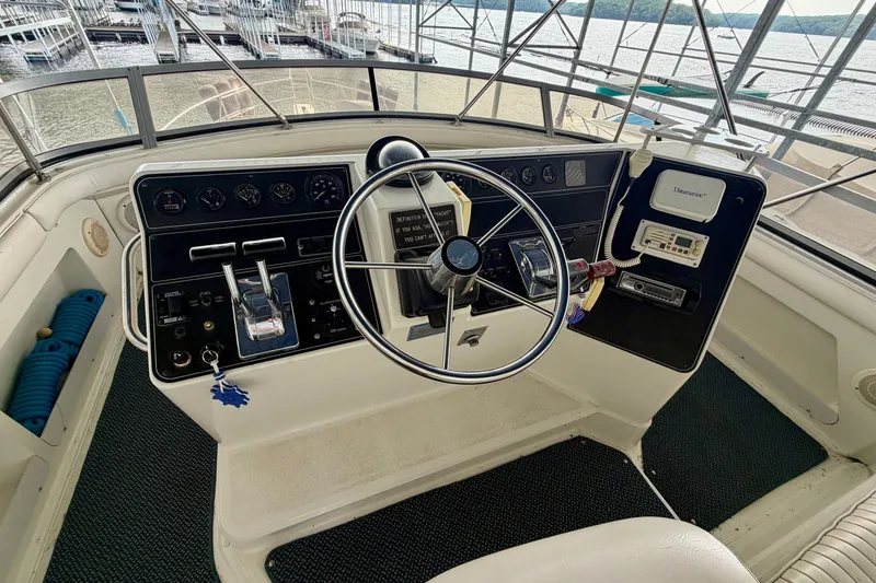 Slide: The Image of Helm of 1994 Carver 440 Aft Cabin Motor Yacht with steering wheel and control panel. - 9
