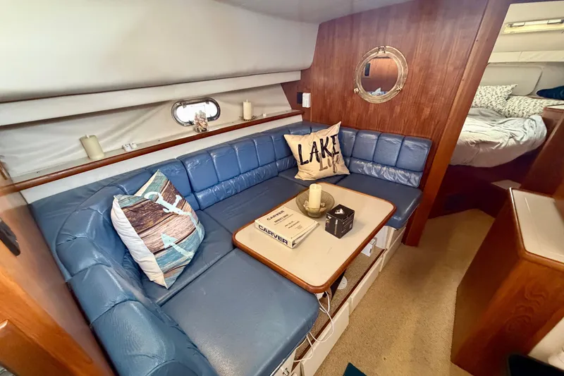 Slide: The Image of Cozy interior of 1994 Carver 440 Aft Cabin Motor Yacht with blue seating and decorative pillows. - 17