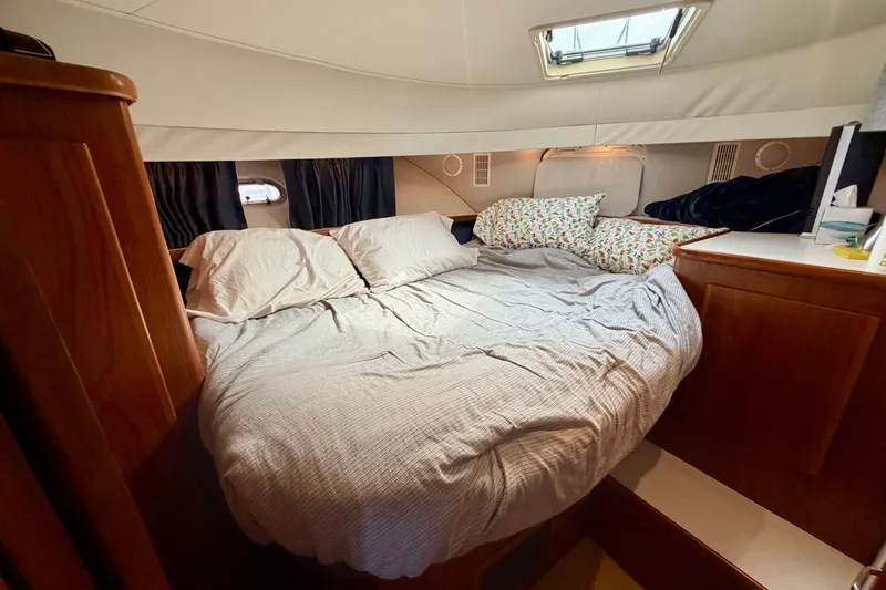 Slide: The Image of Cozy bedroom in 1994 Carver 440 Aft Cabin Motor Yacht with plush bedding and wood accents. - 21