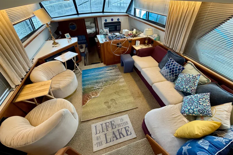 Slide: The Image of Interior of 1994 Carver 440 Aft Cabin Motor Yacht with cozy seating and nautical decor. - 13