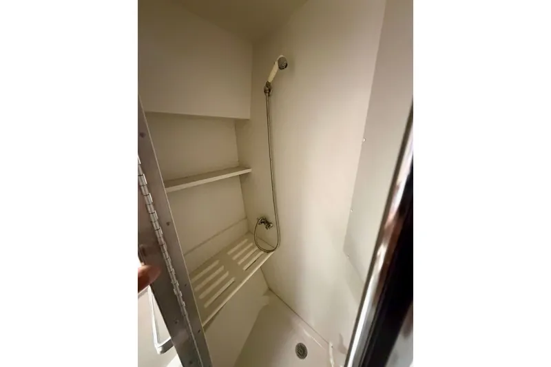 Slide: The Image of Shower area in 1994 Carver 440 Aft Cabin Motor Yacht with shelves and handheld showerhead. - 23