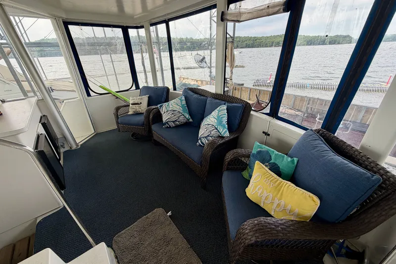 Slide: The Image of Cozy seating area on 1994 Carver 440 Aft Cabin Motor Yacht with lake view. - 3