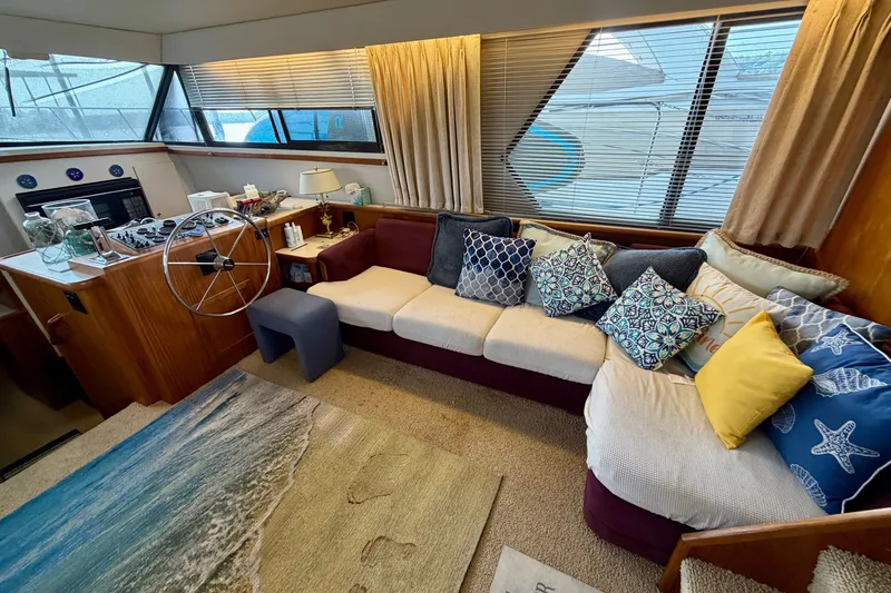 Slide: The Image of Interior of 1994 Carver 440 Aft Cabin Motor Yacht with cozy seating and nautical decor. - 14