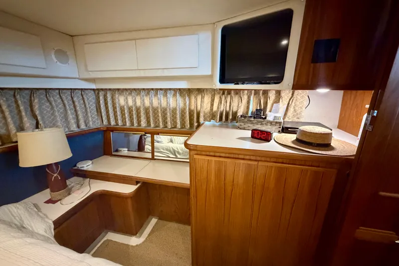 Slide: The Image of Cozy cabin interior of 1994 Carver 440 Aft Cabin Motor Yacht with wood accents and decor. - 25