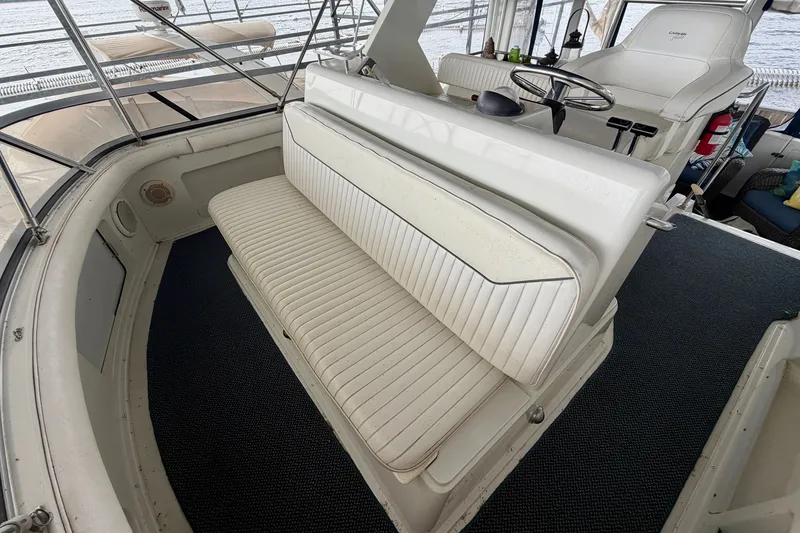Slide: The Image of 1994 Carver 440 Aft Cabin Motor Yacht interior with helm and seating area. - 7